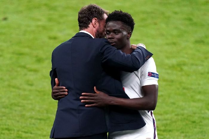 England's Bukayo Saka (right) is congratulated by manager Gareth Southgate